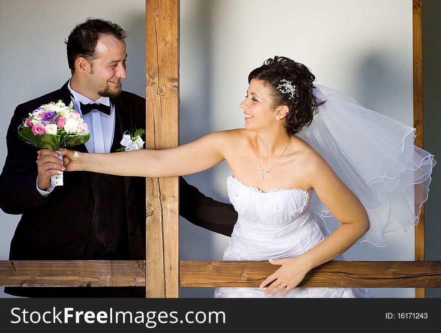 Bride reaching for her wedding bouquet. Bride reaching for her wedding bouquet