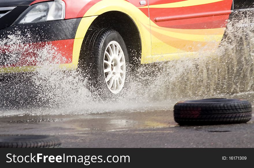 Racing car tires entering water. Racing car tires entering water