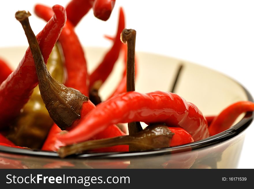 Red hot chili peppers in a bowl isolated over white background