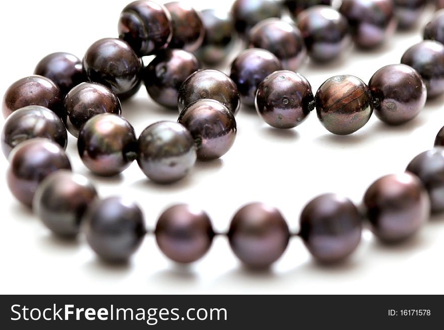 Black pearls necklace isolated over white background