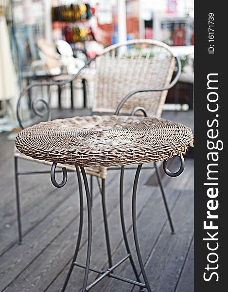 Wicker coffee table. Restaurant little table in the street .