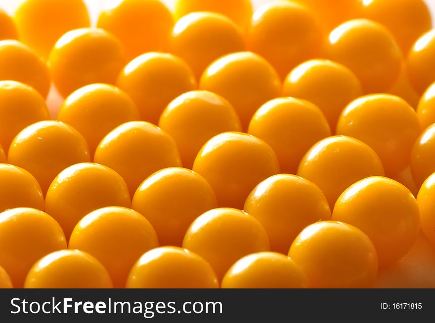 Yellow vitamin pills on a plate