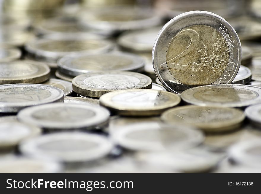 Grungy 2 euro coin with coins on background