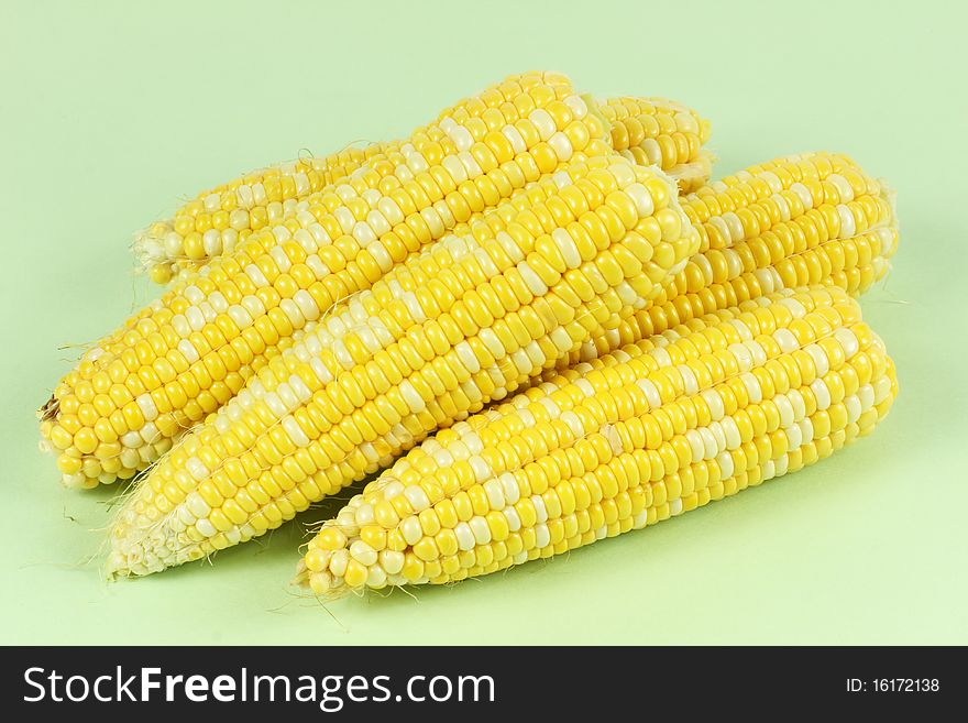 Colorful traditional Thanksgiving corn, isolated on green