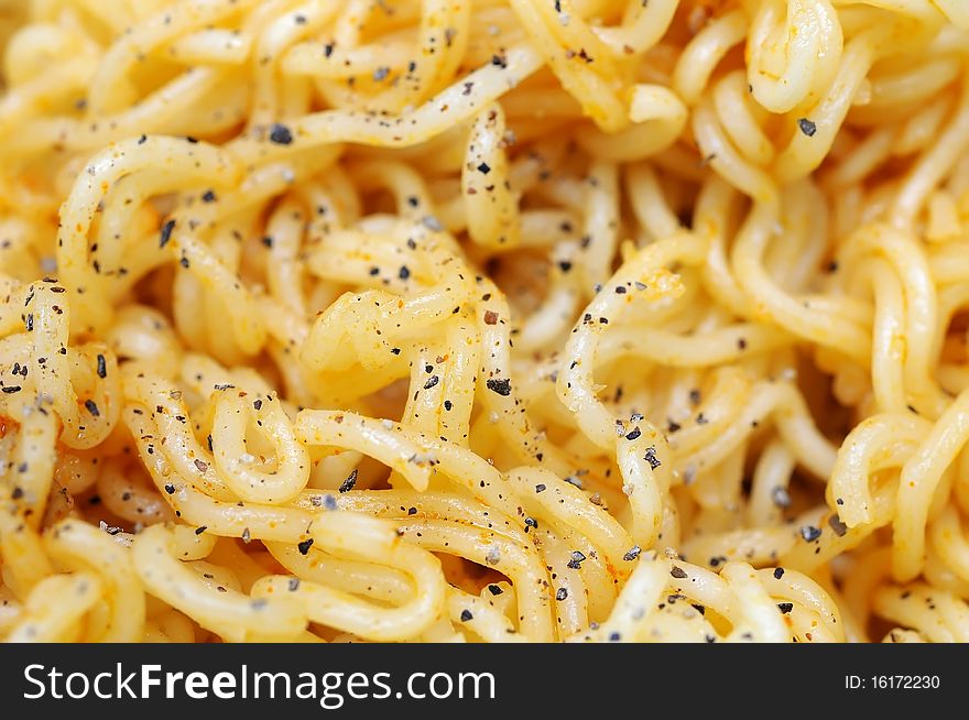 Macro shot of dried noodles with herbal toppings. Suitable for concepts such as diet and nutrition, textures and backgrounds, and food and beverage. Macro shot of dried noodles with herbal toppings. Suitable for concepts such as diet and nutrition, textures and backgrounds, and food and beverage.