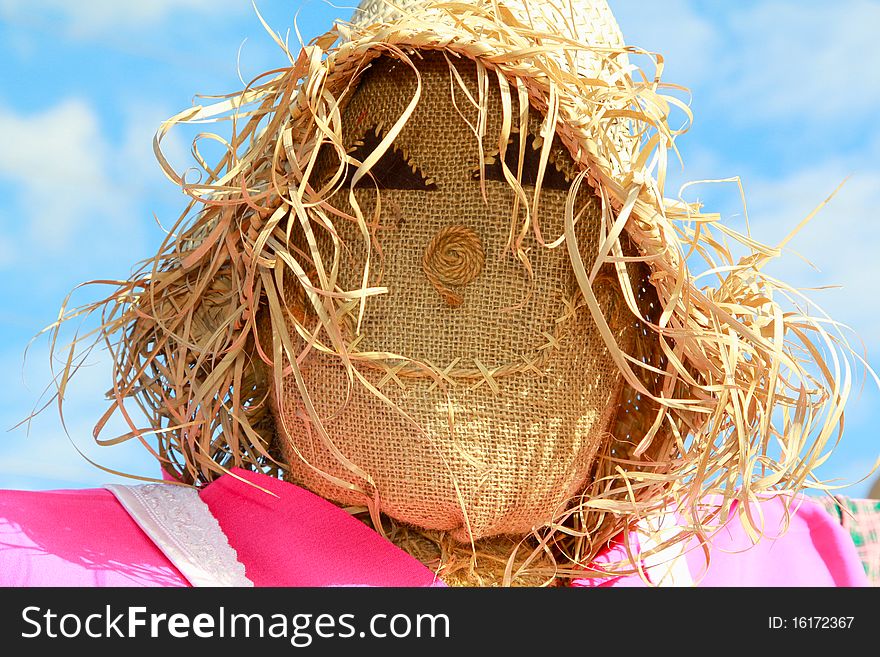 Smiling Lady Scarecrow with straw hair and a hat