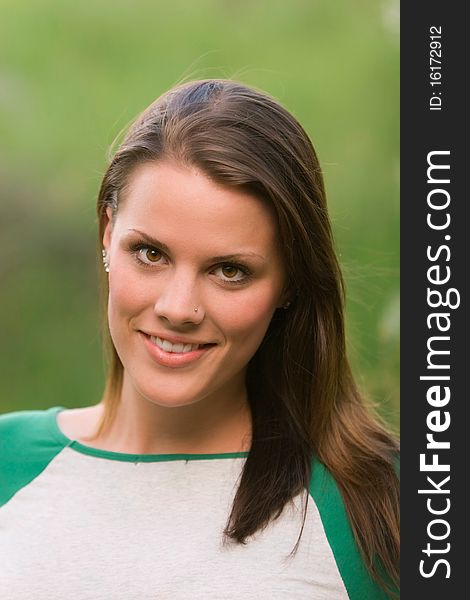 A young model smiling in an outdoor portrait. A young model smiling in an outdoor portrait