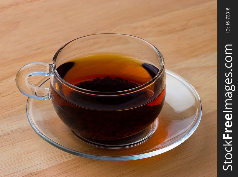 Tea in a Class Cup sat on a wooden table