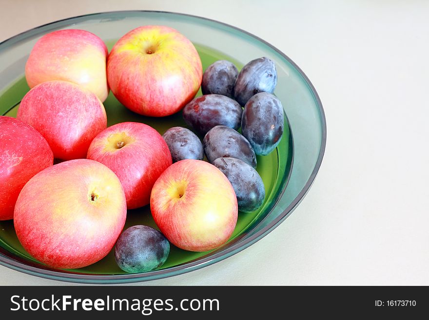 Plums and apples in a bowl. Plums and apples in a bowl