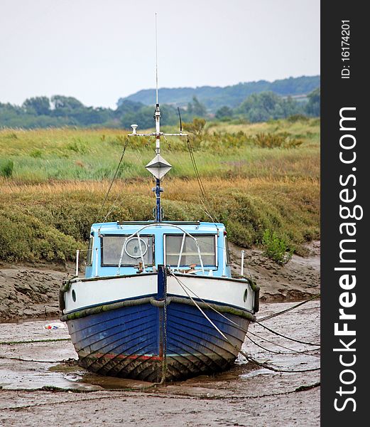 A Moored Boat Stranded in the Mud. A Moored Boat Stranded in the Mud.