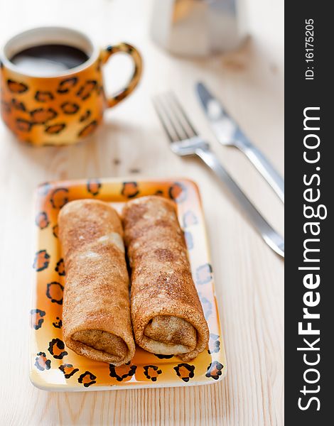 Pancakes with cup of coffee in the background. Pancakes with cup of coffee in the background