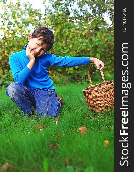 Little boy posing outdoors with mushrooms. Little boy posing outdoors with mushrooms