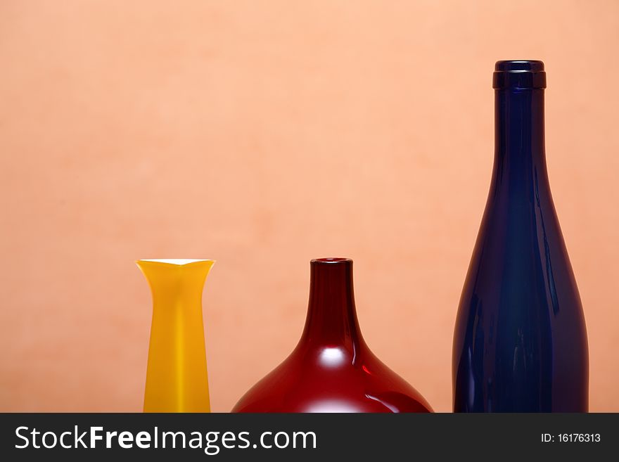 Three various glass motley vases isolated on pink background