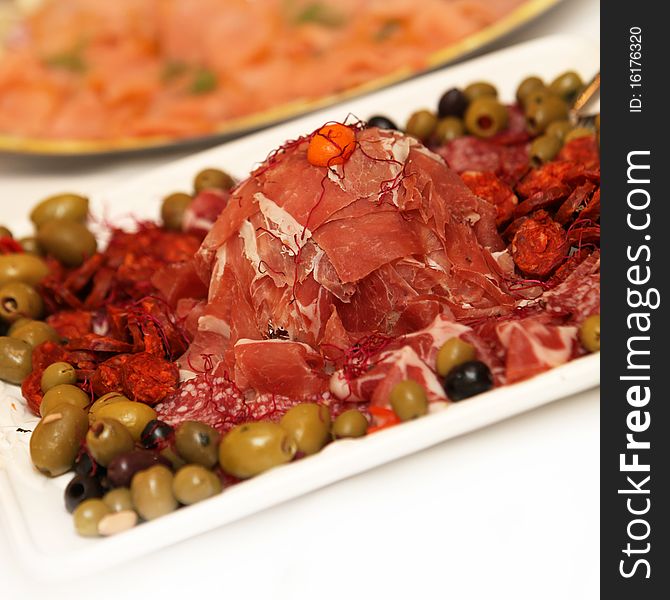 Ham, Salami On A Plate Decorated With Olives