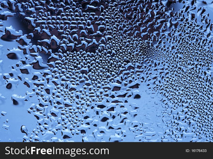 Closeup of crystal clear water drops lying on dark mirror background. Closeup of crystal clear water drops lying on dark mirror background