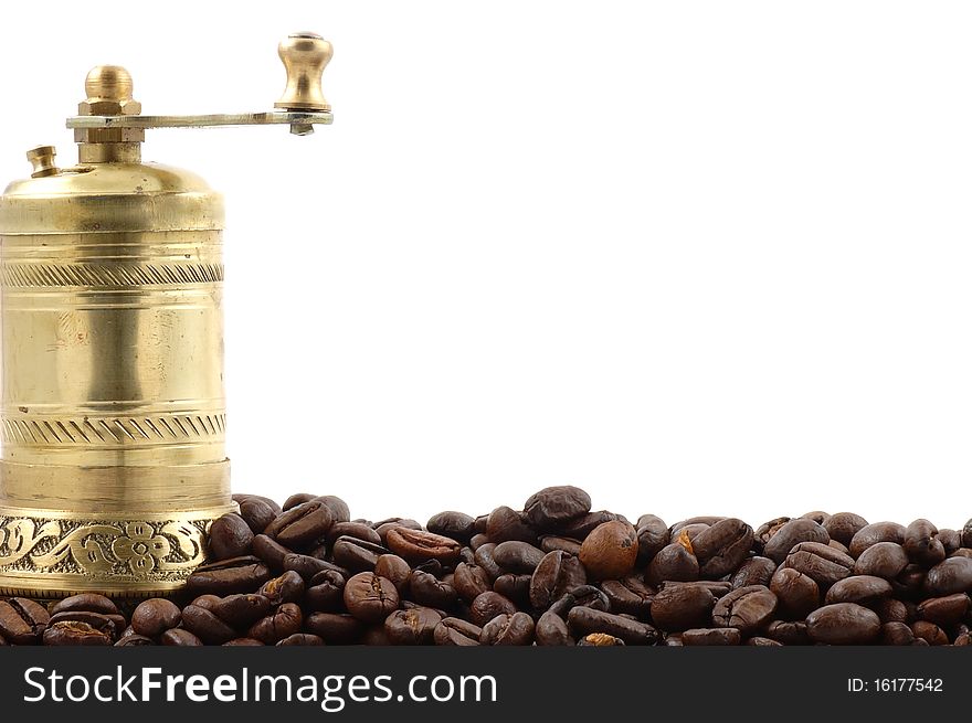 Crusher of coffee with coffee grains on a white background close up. Crusher of coffee with coffee grains on a white background close up