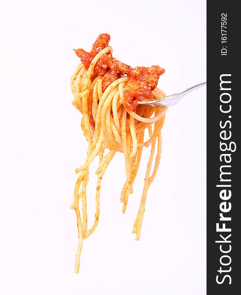 Spaghetti with bolognese sauce hanging on a fork. Spaghetti with bolognese sauce hanging on a fork