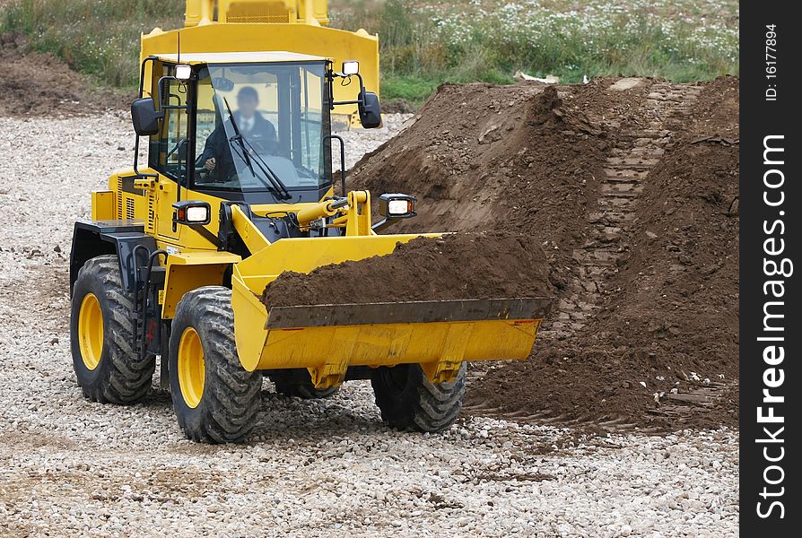 The image of bulldozer works at the ground