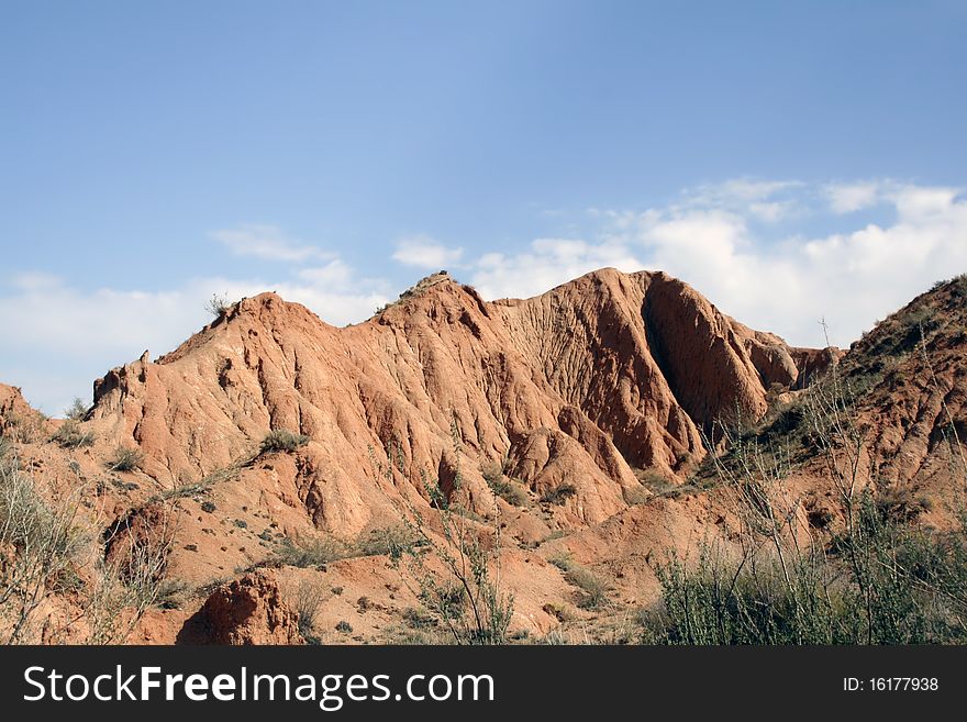 Canyon from red clay with sand, created Ð²ÐµÑ‚Ñ€Ð¾Ð¼ and water