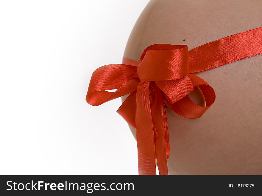 Red ribbon, a bow on a pregnant woman