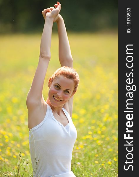 Young woamn doing physical exercise outdoors. Young woamn doing physical exercise outdoors