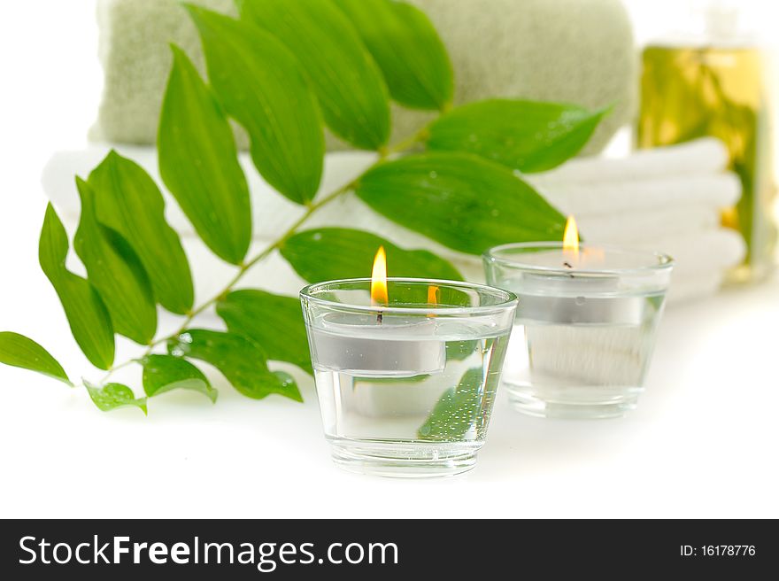 Spa with herbal tincture and green leaf on white