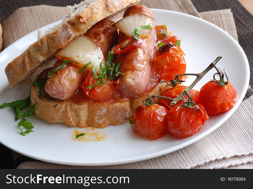 Sausage and tomato sandwich on a plate