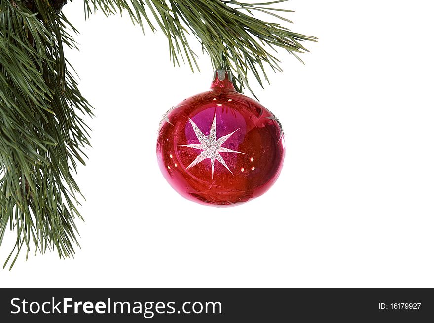 Christmas decoration -red ball in pine branch close up isolated in white