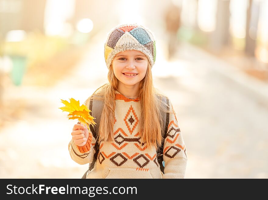 Cute school girl with leaves