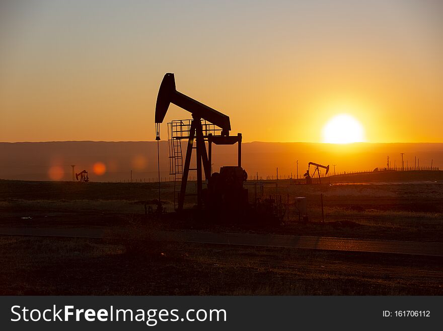 View of Oil Well Pumpjack Horsehead at Sunset Oil Industry. View of Oil Well Pumpjack Horsehead at Sunset Oil Industry