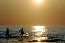 Two Silhouetted Kids Kick Stock Photo Two Silhouetted Kids Kick Stock Photo