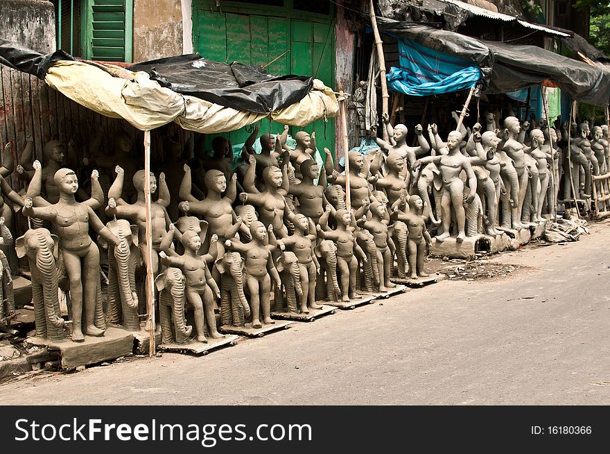 Numerous clay idols for sale on the eve of Viswakarma puja festival in a street in Kolkata, India