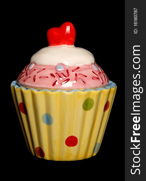 Ceramic cupcake ornament isolated on black background