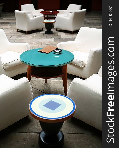 Cafe indoor with white sofas and blue glass small table. Cafe indoor with white sofas and blue glass small table