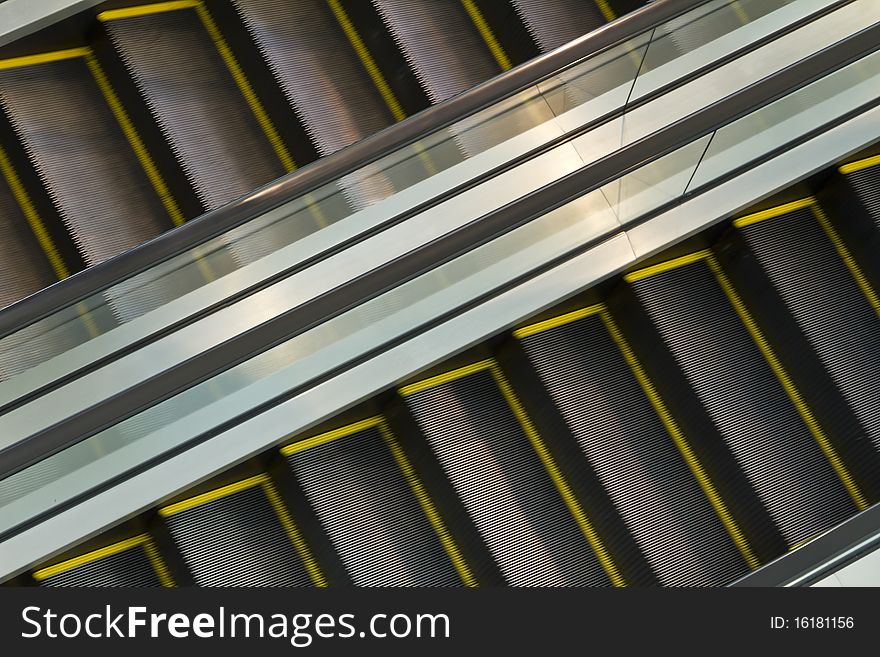Escalator in motion, transportation and travel respresented