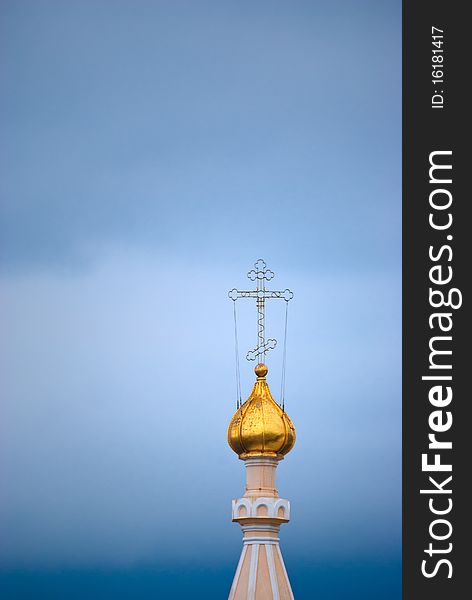 Gold dome of an orthodox temple with a cross