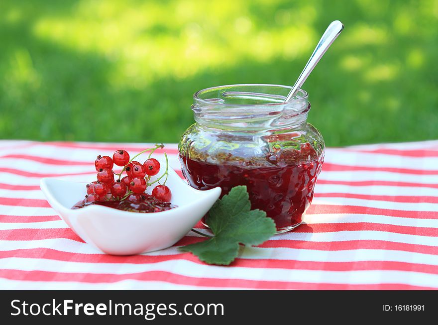 Jar of red currant jam on the napkin