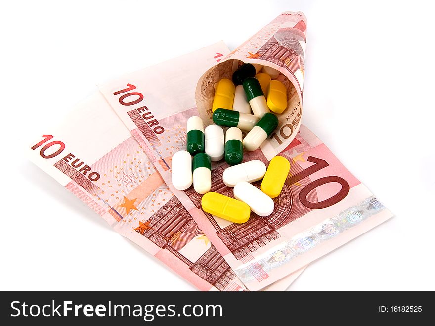 Scattered pills on money on white background. Scattered pills on money on white background