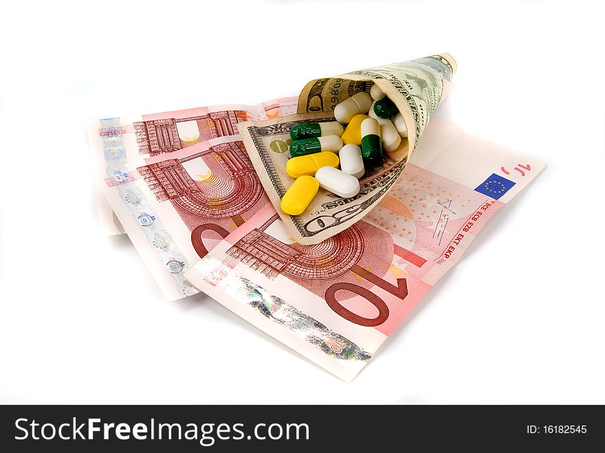 Scattered pills on money on white background. Scattered pills on money on white background