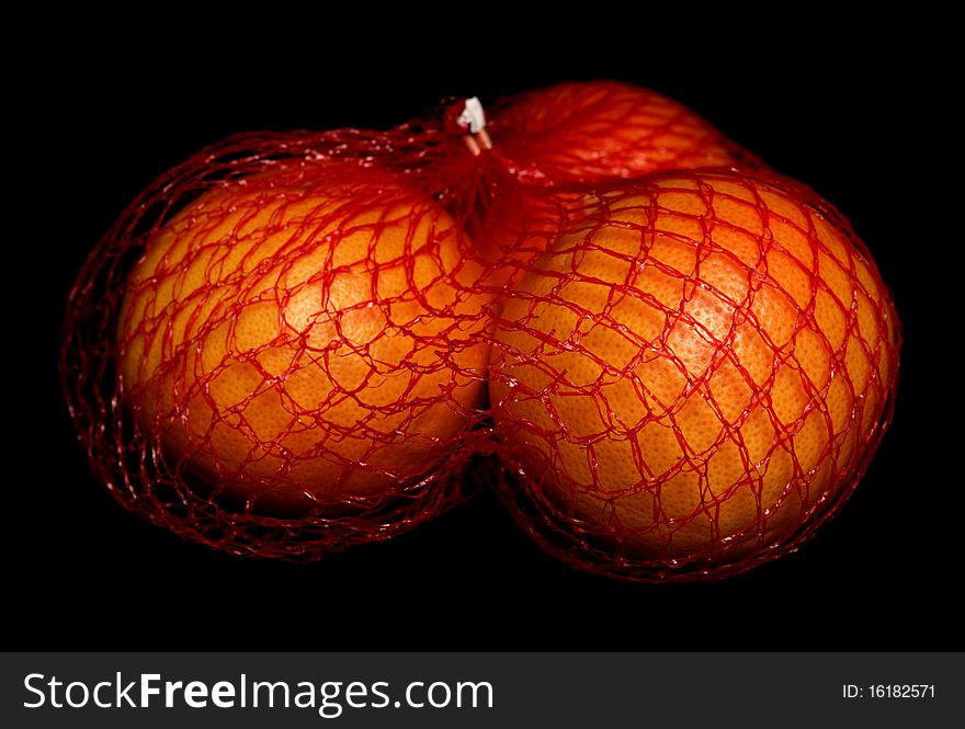 Three oranges isolated on black background