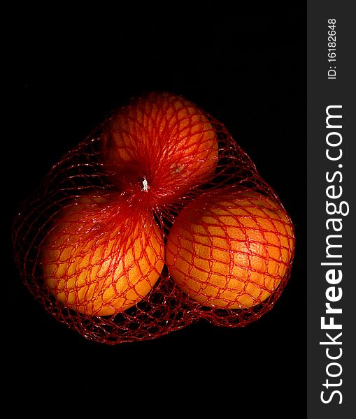 Three oranges isolated on a black background