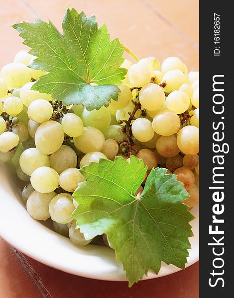 Clusters of green grapes on the plate