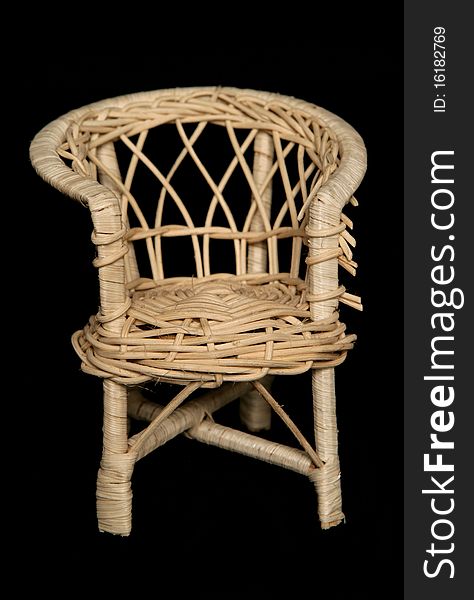 Wicker chair isolated on black background