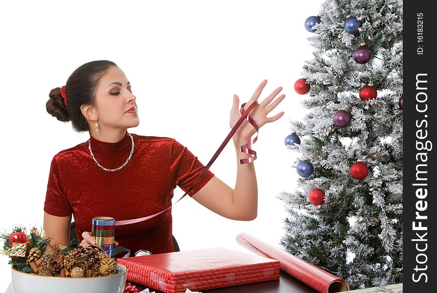 Woman wrapping christmas presents against white background. Woman wrapping christmas presents against white background
