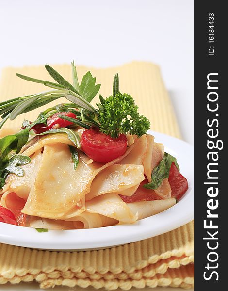 Pasta with tomatoes and salad greens - closeup. Pasta with tomatoes and salad greens - closeup