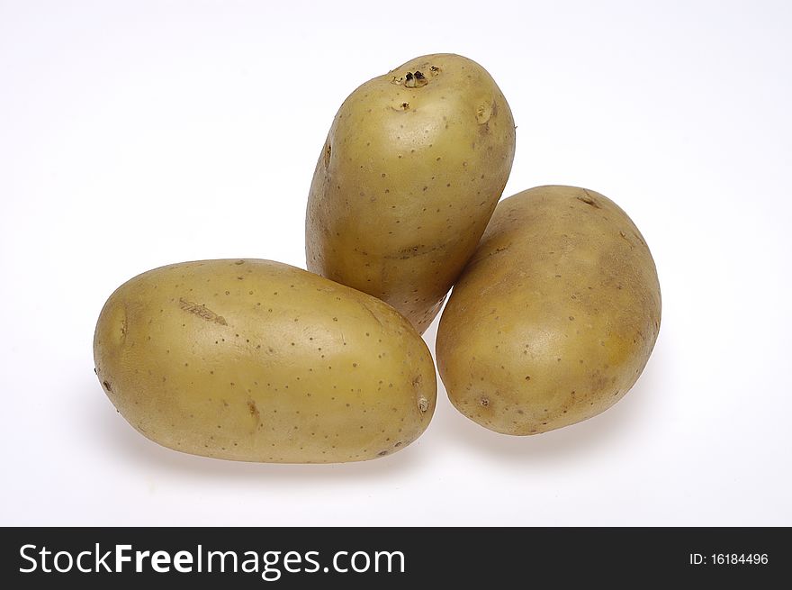 Three potatoes on white background.
