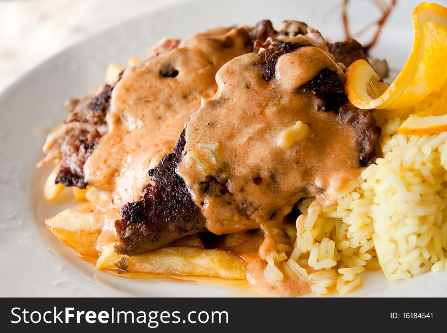 Steak with ham,cheese and french fries . Steak with ham,cheese and french fries .