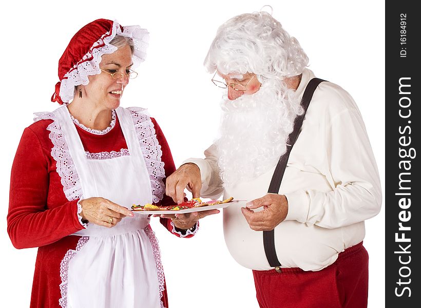 Mrs. Claus serving Christmas cookies to Santa.  Isolated on white. Mrs. Claus serving Christmas cookies to Santa.  Isolated on white.