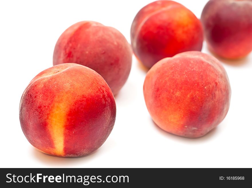 Fresh red peaches isolated on white background