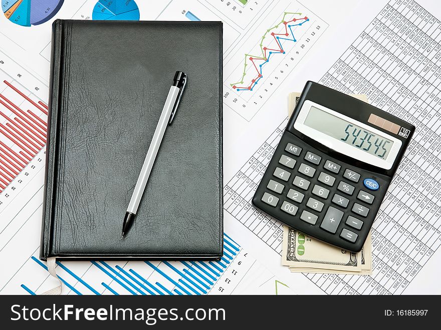 Financial chart with calculator,pen,notebook and money. Financial chart with calculator,pen,notebook and money